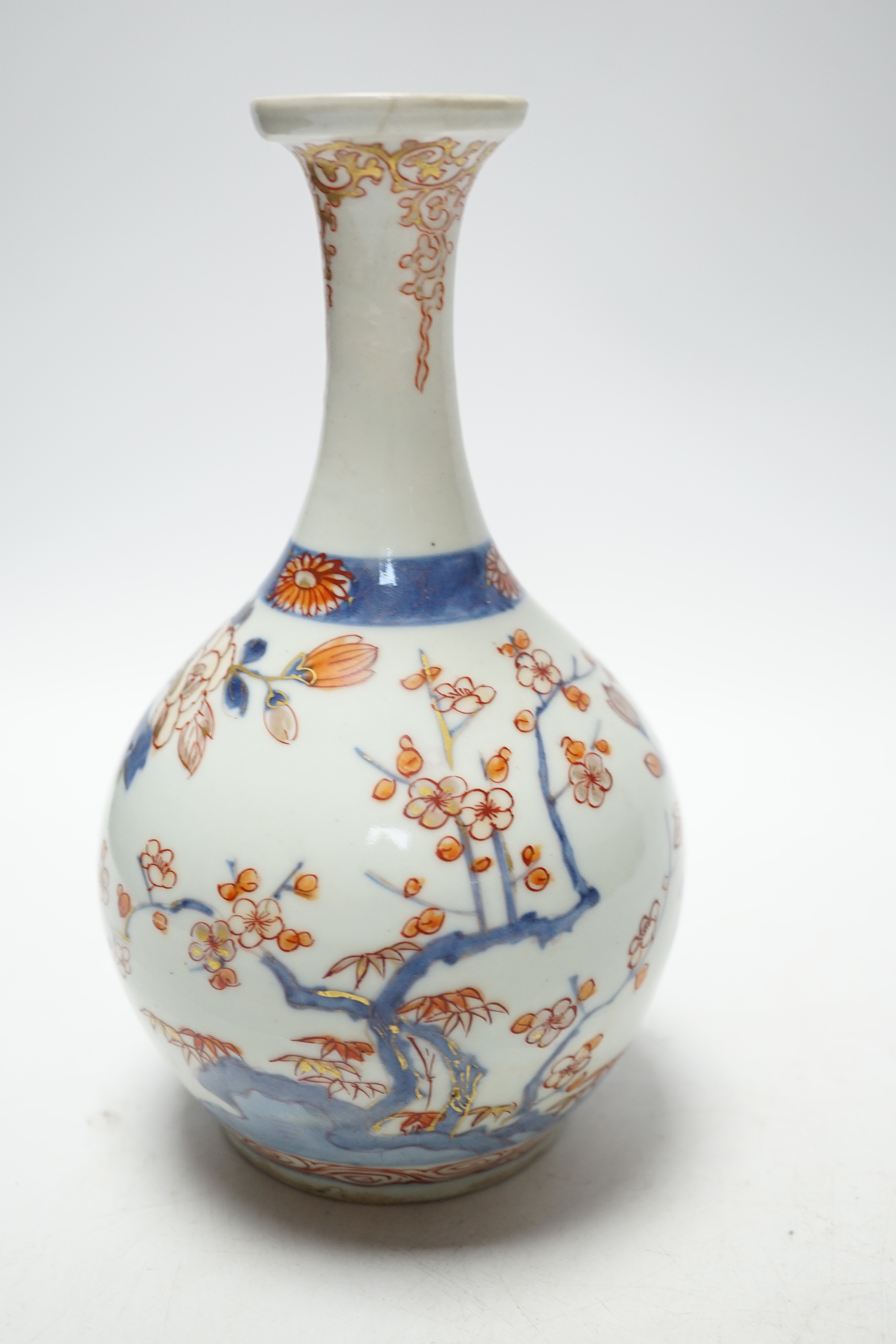 An 18th century Japanese Imari sake flask and a Chinese clobbered blue and white bowl (a.f), tallest 20cm